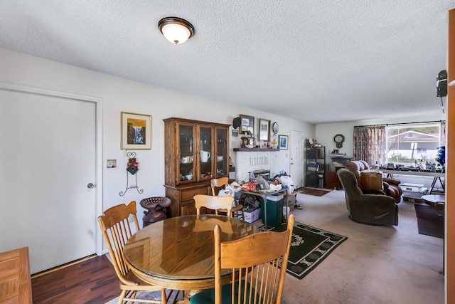 1401 W 1st St, Newport, WA 99156 - dining room featuring a textured ceiling and a brick fireplace