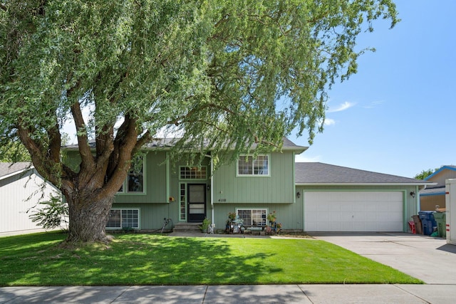 4110 E Ermina Ave, Spokane, WA 99217 - view of front facade with concrete driveway, an attached garage, and a front yard