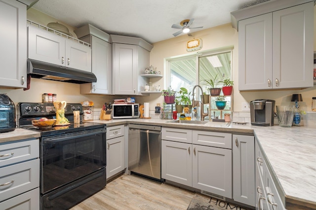 4110 E Ermina Ave, Spokane, WA 99217 - kitchen featuring dishwasher, black range with electric stovetop, under cabinet range hood, and light countertops
