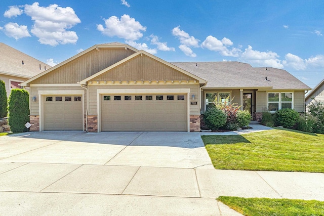 7014 E Columbia Dr, Spokane, WA 99217 - view of front of house with an attached garage, concrete driveway, a front yard, and stone siding