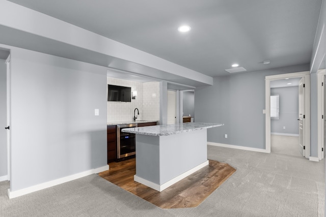 7014 E Columbia Dr, Spokane, WA 99217 - kitchen with beverage cooler, dark carpet, a kitchen island, recessed lighting, and backsplash