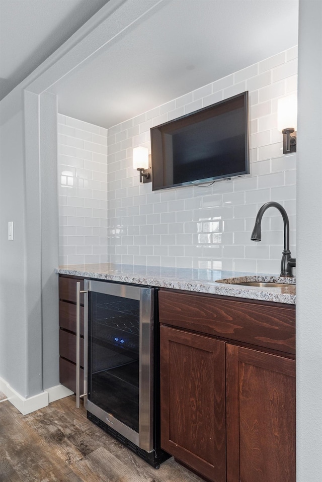 7014 E Columbia Dr, Spokane, WA 99217 - bar featuring beverage cooler, dark wood-type flooring, and tasteful backsplash