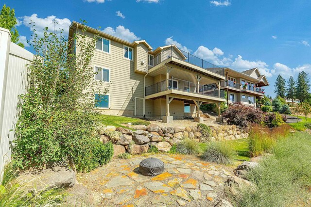 7014 E Columbia Dr, Spokane, WA 99217 - back of house featuring a balcony, a fire pit, and a patio area