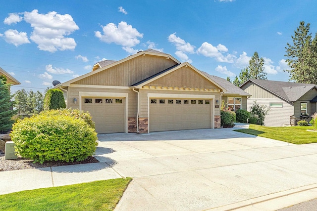 7014 E Columbia Dr, Spokane, WA 99217 - view of front facade with an attached garage, concrete driveway, and stone siding