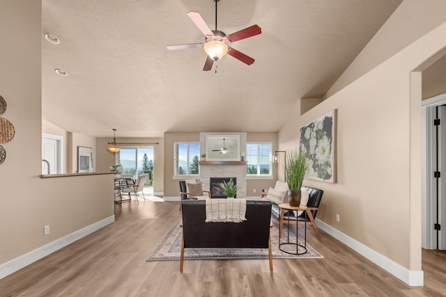 7014 E Columbia Dr, Spokane, WA 99217 - living area featuring a ceiling fan, plenty of natural light, wood finished floors, and a large fireplace