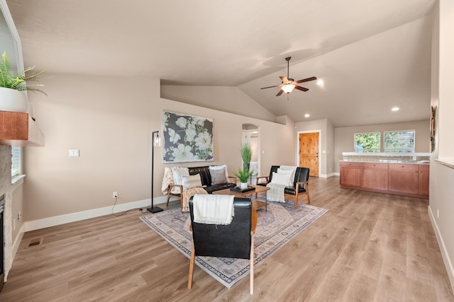 7014 E Columbia Dr, Spokane, WA 99217 - living area featuring a glass covered fireplace, arched walkways, ceiling fan, light wood-style flooring, and recessed lighting