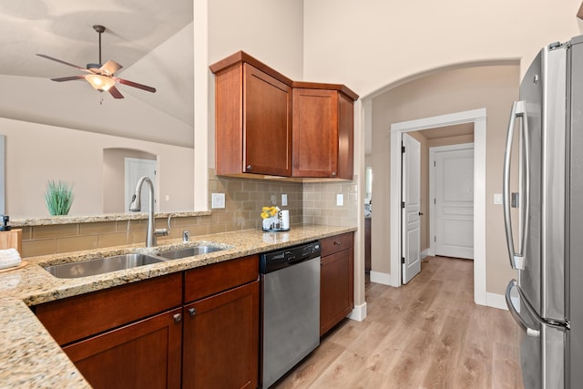 7014 E Columbia Dr, Spokane, WA 99217 - kitchen with appliances with stainless steel finishes, arched walkways, ceiling fan, light stone countertops, and lofted ceiling