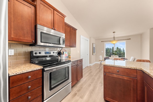 7014 E Columbia Dr, Spokane, WA 99217 - kitchen with appliances with stainless steel finishes, tasteful backsplash, light wood-style floors, brown cabinets, and vaulted ceiling