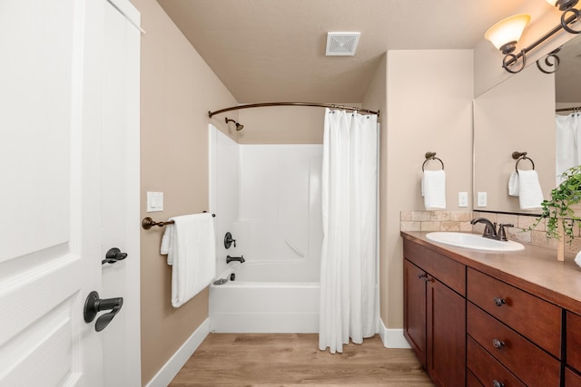 7014 E Columbia Dr, Spokane, WA 99217 - full bathroom with vanity, wood finished floors, shower / bath combo, and tasteful backsplash