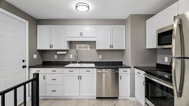 6121 N Belt St, Spokane, WA 99205 - kitchen with appliances with stainless steel finishes, light marble finish floors, white cabinets, and dark countertops