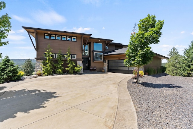 14210 N Wandermere Estates Ln, Spokane, WA 99208 - view of front of property featuring concrete driveway, stone siding, and an attached garage