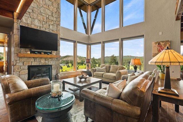 14210 N Wandermere Estates Ln, Spokane, WA 99208 - living room featuring healthy amount of natural light, a fireplace, beamed ceiling, and a towering ceiling