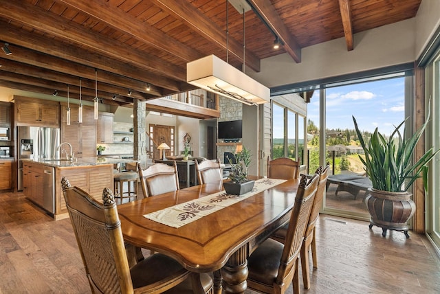 14210 N Wandermere Estates Ln, Spokane, WA 99208 - dining area with a wood ceiling with exposed beams, wood-type flooring, rail lighting, and a fireplace