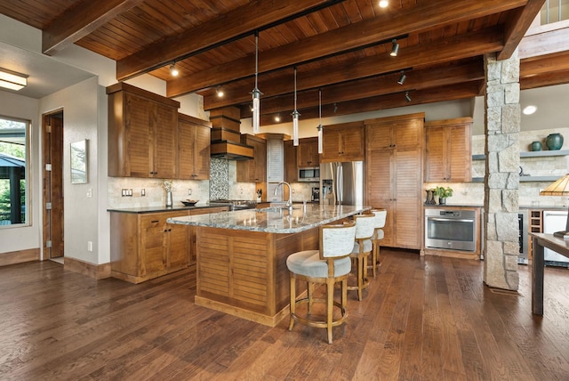 14210 N Wandermere Estates Ln, Spokane, WA 99208 - kitchen with appliances with stainless steel finishes, track lighting, a wood ceiling with exposed beams, dark wood finished floors, and brown cabinetry