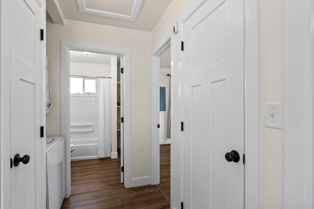 10124 N Wellen Ln, Spokane, WA 99218 - corridor with dark wood-style flooring and washing machine and clothes dryer