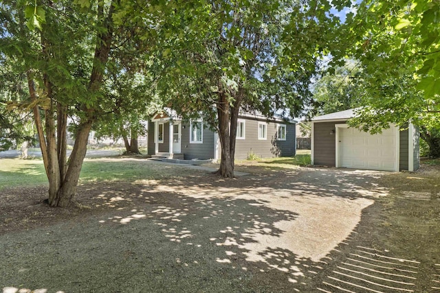 10124 N Wellen Ln, Spokane, WA 99218 - view of front of home with concrete driveway, an outdoor structure, and a garage