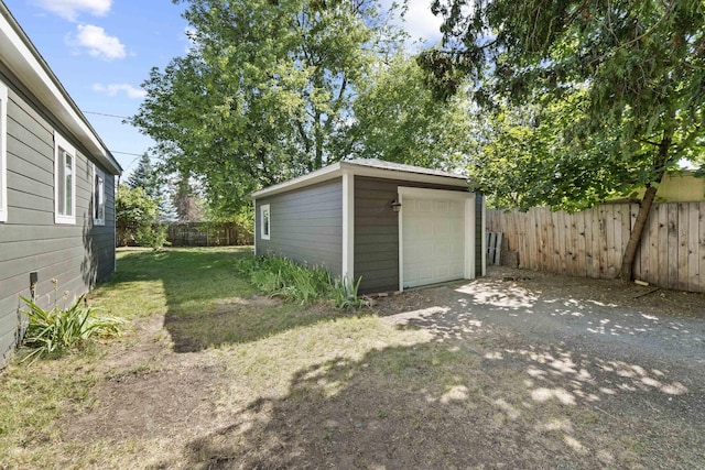 10124 N Wellen Ln, Spokane, WA 99218 - fenced backyard featuring an outbuilding, a garage, and driveway