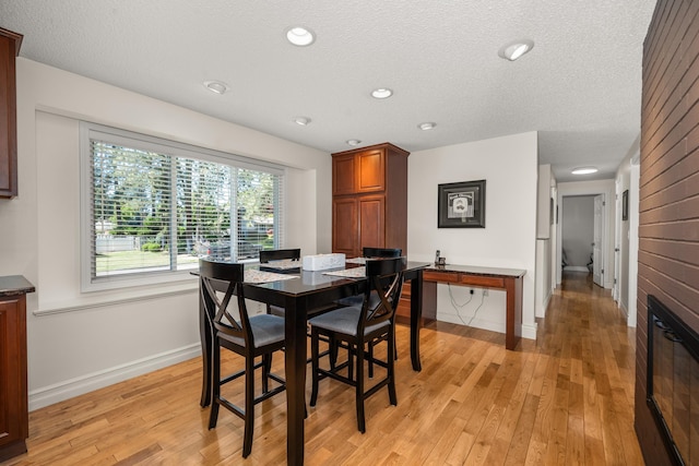 11912 N Atlantic St, Spokane, WA 99218 - dining area with light wood-style floors, a textured ceiling, and recessed lighting