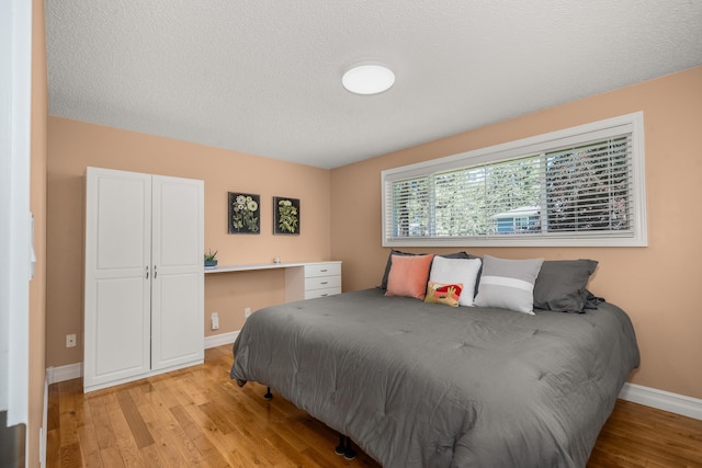 11912 N Atlantic St, Spokane, WA 99218 - bedroom with light wood-style floors and a textured ceiling