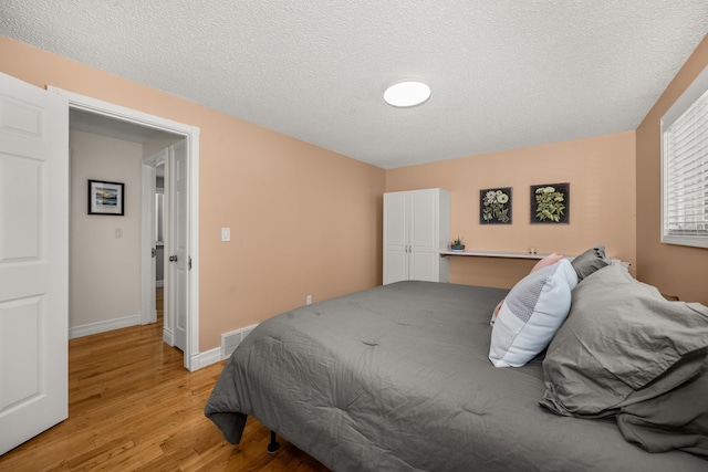 11912 N Atlantic St, Spokane, WA 99218 - bedroom featuring light wood finished floors and a textured ceiling