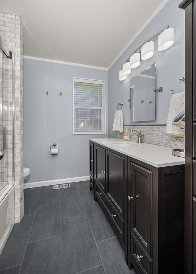 11912 N Atlantic St, Spokane, WA 99218 - full bathroom with vanity, crown molding, tile patterned floors, tasteful backsplash, and combined bath / shower with glass door