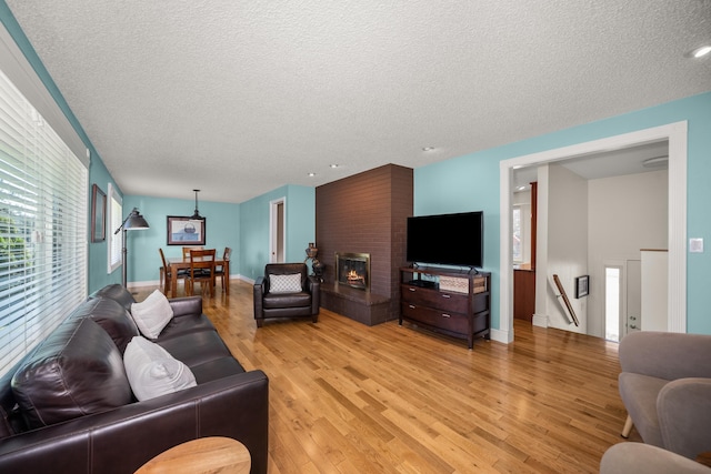 11912 N Atlantic St, Spokane, WA 99218 - living room featuring a textured ceiling, light wood-type flooring, and recessed lighting