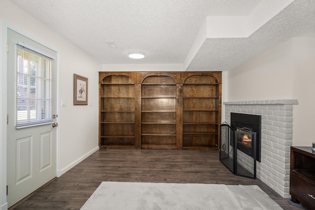 11912 N Atlantic St, Spokane, WA 99218 - interior space featuring a textured ceiling, wood finished floors, and a brick fireplace