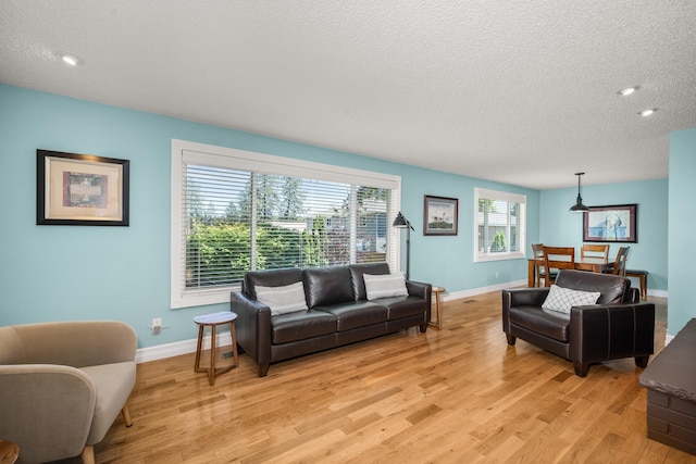11912 N Atlantic St, Spokane, WA 99218 - living room with light wood-style flooring, a textured ceiling, and recessed lighting
