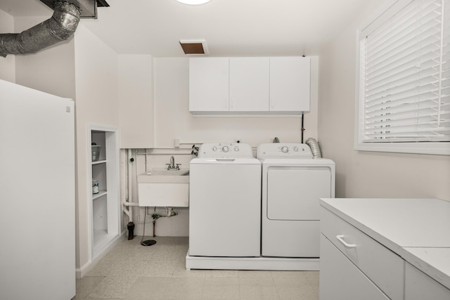 11912 N Atlantic St, Spokane, WA 99218 - laundry area featuring cabinet space, washer and dryer, and light floors
