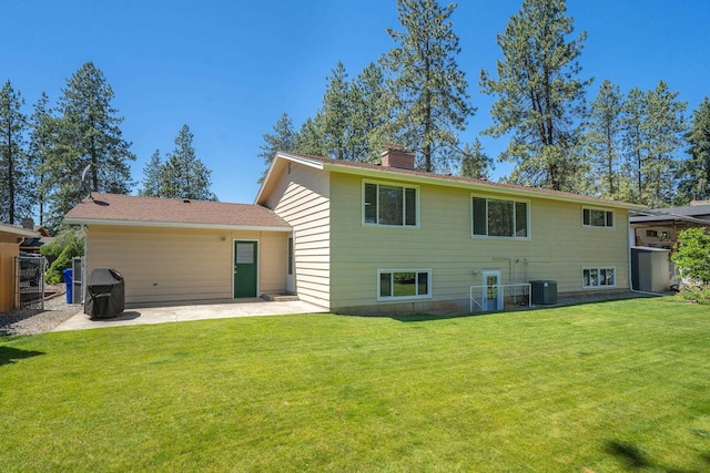 11912 N Atlantic St, Spokane, WA 99218 - back of house featuring a patio, a yard, and a chimney