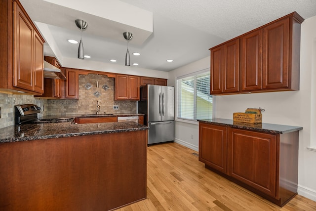 11912 N Atlantic St, Spokane, WA 99218 - kitchen with freestanding refrigerator, range with electric cooktop, ventilation hood, a peninsula, and light wood-type flooring