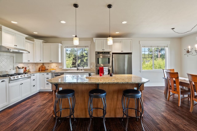7116 S Linke Rd, Greenacres, WA 99016 - kitchen featuring stainless steel appliances, recessed lighting, decorative backsplash, dark wood-type flooring, and a kitchen island