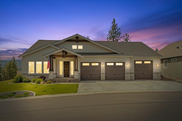 12918 E San Juan Ln, Spokane, WA 99206 - craftsman inspired home featuring stone siding, an attached garage, driveway, and a front yard