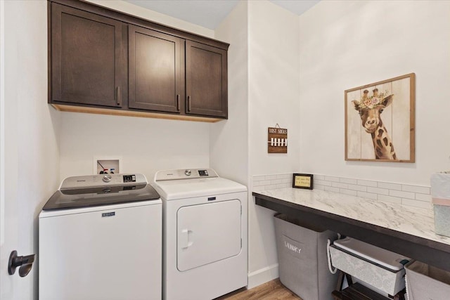 12918 E San Juan Ln, Spokane, WA 99206 - washroom featuring cabinet space, washing machine and clothes dryer, and light wood-style flooring