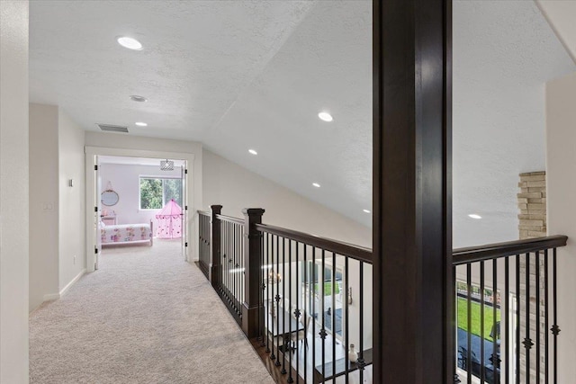 12918 E San Juan Ln, Spokane, WA 99206 - hall featuring lofted ceiling, carpet, recessed lighting, and a textured ceiling