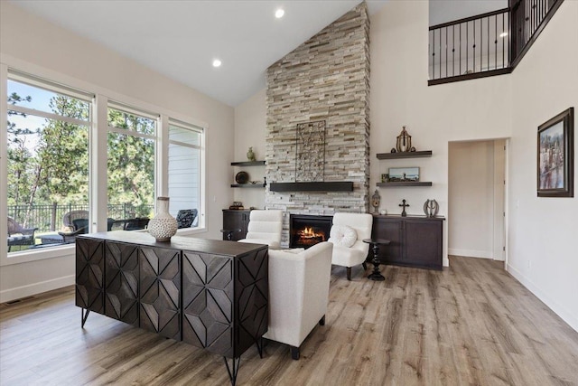 12918 E San Juan Ln, Spokane, WA 99206 - living area featuring high vaulted ceiling, wood finished floors, a stone fireplace, and recessed lighting