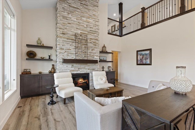 12918 E San Juan Ln, Spokane, WA 99206 - living room with a fireplace, a high ceiling, and wood finished floors