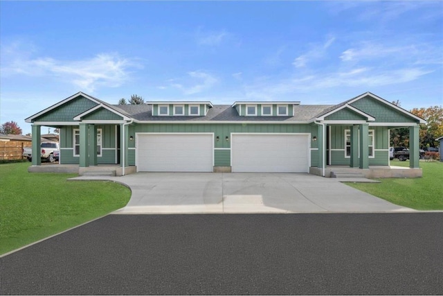 11514 E 13th Ln Unit 11516, Spokane Valley, WA 99206 - view of front facade with covered porch, an attached garage, concrete driveway, and board and batten siding