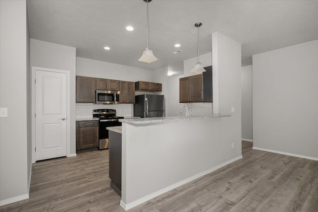 11514 E 13th Ln Unit 11516, Spokane Valley, WA 99206 - kitchen featuring stainless steel appliances, backsplash, light wood-type flooring, recessed lighting, and a peninsula