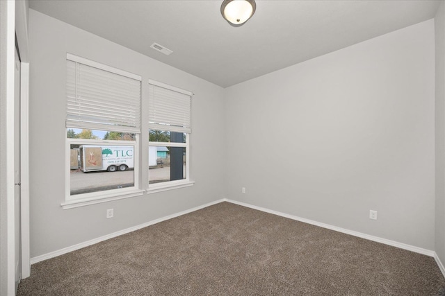 11514 E 13th Ln Unit 11516, Spokane Valley, WA 99206 - spare room featuring dark colored carpet and baseboards