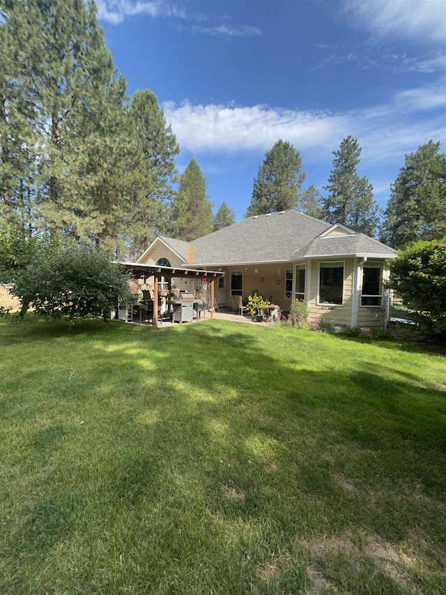 603 W Dennison-Chattaroy Rd, Deer Park, WA 99006 - back of house with a lawn, a patio, and a shingled roof