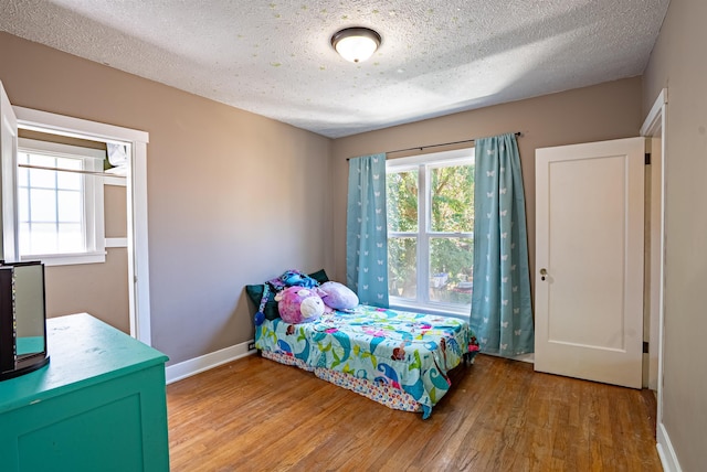 3927 N Jefferson St, Spokane, WA 99205 - bedroom with wood finished floors and a textured ceiling