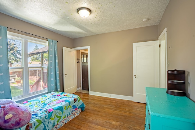 3927 N Jefferson St, Spokane, WA 99205 - bedroom featuring light wood-style flooring and a textured ceiling