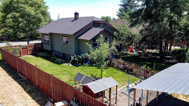3927 N Jefferson St, Spokane, WA 99205 - back of property with a fenced backyard, a chimney, roof with shingles, exterior structure, and an outdoor structure