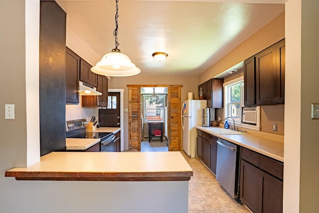 3927 N Jefferson St, Spokane, WA 99205 - kitchen featuring stainless steel appliances, under cabinet range hood, dark brown cabinets, light countertops, and decorative light fixtures
