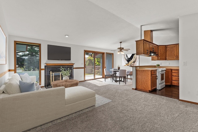 3707 S Alder Ct, Spokane, WA 99223 - living area featuring dark carpet, a tile fireplace, and a ceiling fan