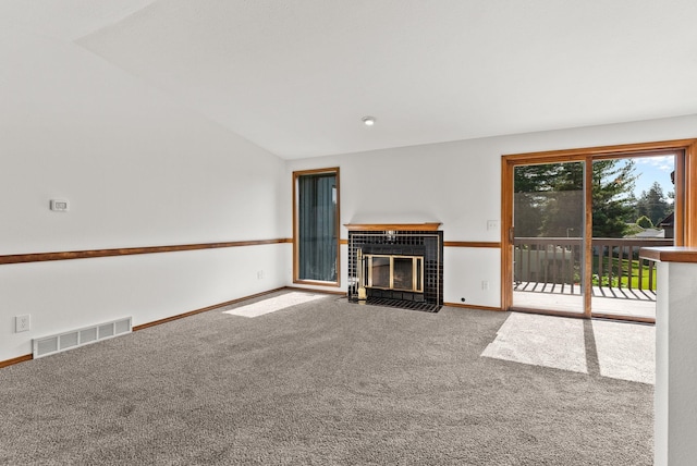 3707 S Alder Ct, Spokane, WA 99223 - unfurnished living room featuring carpet flooring, a tiled fireplace, and vaulted ceiling