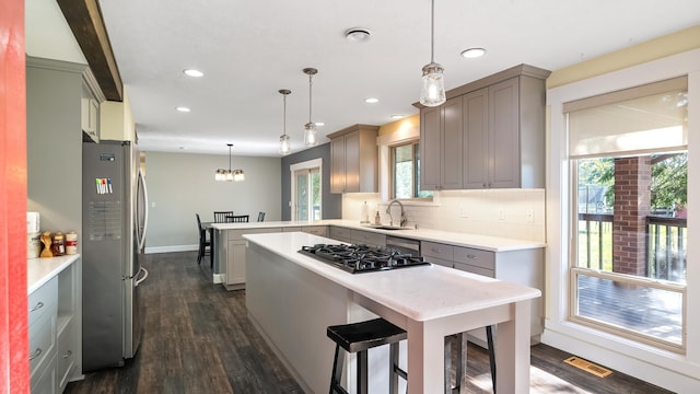 17207 N Mt Spokane Park Dr, Mead, WA 99021 - kitchen with stainless steel appliances, a peninsula, light countertops, dark wood-style floors, and recessed lighting