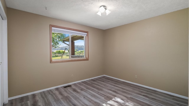 17207 N Mt Spokane Park Dr, Mead, WA 99021 - unfurnished room featuring wood finished floors and a textured ceiling