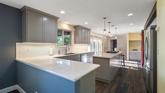 17207 N Mt Spokane Park Dr, Mead, WA 99021 - kitchen featuring stainless steel appliances, a center island, dark wood-style flooring, tasteful backsplash, and recessed lighting